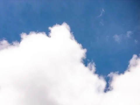 Large White Cumulus Cloud Against a Rich Blue Sky Stock Photos