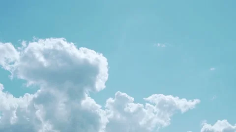 A Large White Cumulus Cloud in a Blue Sky in the Sunlight on A Sunny Summer Day, Video stock 160411630