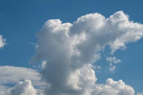 Large white cumulus cloud formation against clear blue sky Stock Photos