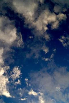 Large white cumulus clouds on a blue sky for background or ecology or nature. Stock Photos