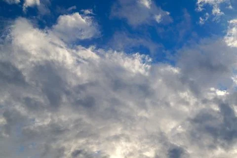 Large white cumulus clouds on a blue sky for background or ecology or nature. Stock Photos