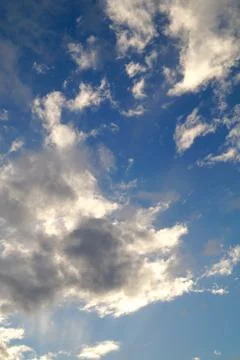 Large white cumulus clouds on a blue sky for background or ecology or nature. Stock Photos