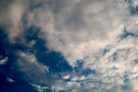 Large white cumulus clouds on a blue sky for background or ecology or nature. Stock Photos