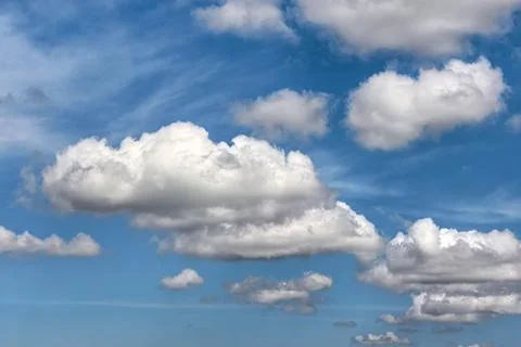 Large White Cumulus Clouds In Bright Blue Sky Stock Photos