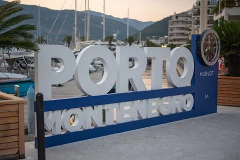Large white dimensional sign spelling 'PORTO MONTENEGRO' on waterfront promenade Stock Photos
