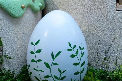 Large white easter egg decorated with green leaves in garden. Spring festiv.. Stock Photos