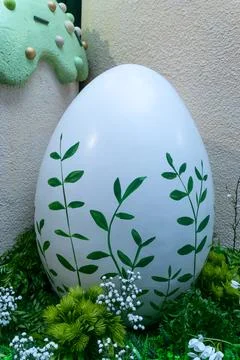 Large white easter egg decorated with green leaves in garden. Spring festiv.. Stock Photos