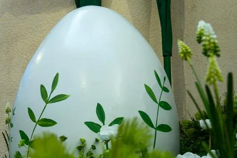 Large white easter egg decorated with green leaves in garden. Spring festiv.. Stock Photos