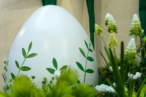Large white easter egg decorated with green leaves in garden. Spring festiv.. Stock Photos
