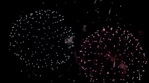 Large white fireworks exploding in the sky at night Stock Footage 329676342