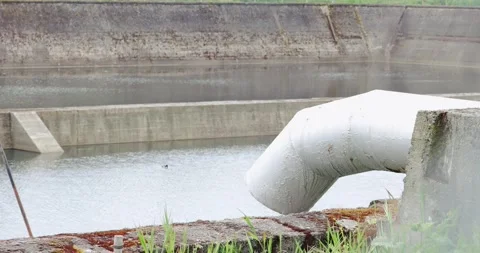 Large white industrial pipe over concrete water reservoir 스톡 동영상 333347517