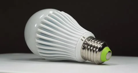 Large white LED lamp rotates on a dark background Stock Footage 330259717