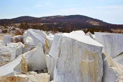 Large white marble blocks in an old abandoned quarry Stock Photos