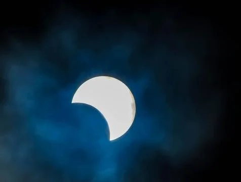 A large white moon is visible in the sky, with a blue and cloudy background Stock Photos