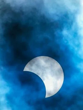 A large white moon is visible in the sky, with a blue and cloudy background Stock Photos