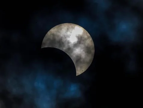 A large white moon is visible in the sky, with a blue and cloudy background Stock Photos