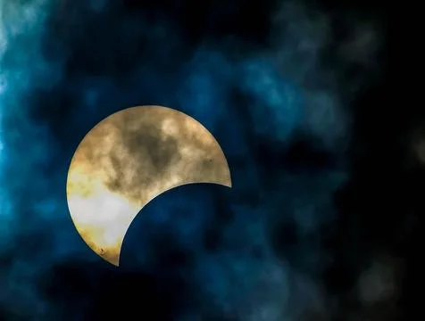A large white moon is visible in the sky, with a blue and cloudy background Stock Photos