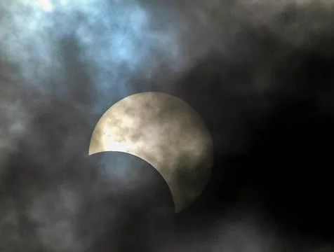 A large white moon is visible in the sky, with a blue and cloudy background Stock Photos