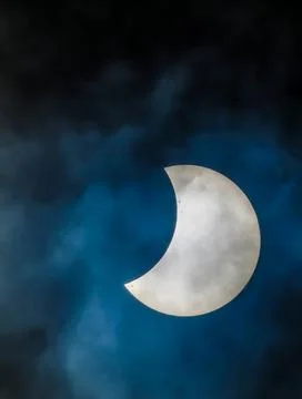 A large white moon is visible in the sky, with a blue and cloudy background Stock Photos