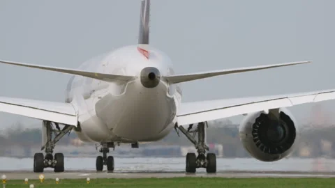 Large white passenger aircraft preparing for takeoff on runway, rear close up Stock Footage 333646728