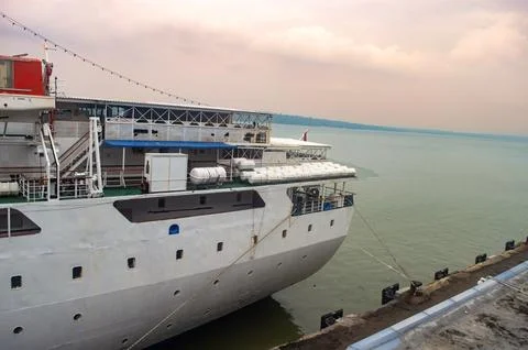 A large white passenger ship is docked at tanjung perak port in surabaya, w.. Photos