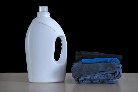 Large white plastic bottle of laundry black background Stock Photos