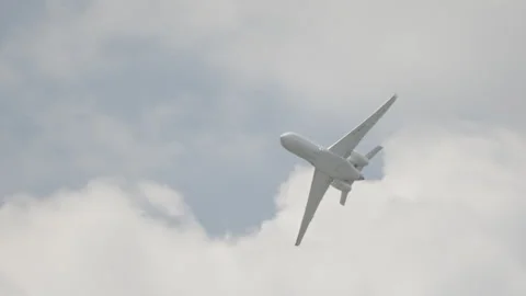 Large white private business Jet during flight under blue sky with clouds Stock Footage 246133995