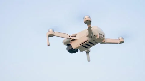 A large white quadcopter with a camera slowly flips in the air. Slow motion. Video stock 228684837