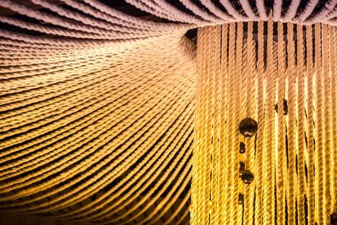 A large white rope structure with a yellowish hue Stock Photos
