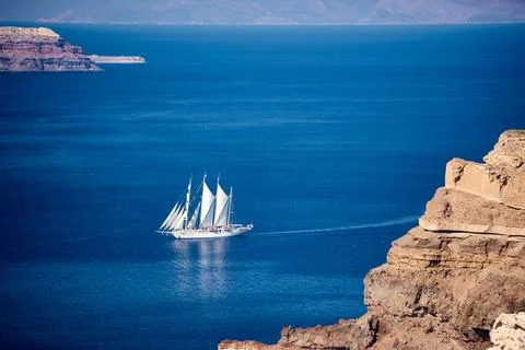 Large white sailing ship with multiple masts navigating the blue Aegean Sea n Stock Photos