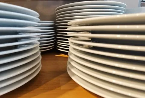 Large white serving plates stacked up Stock Photos