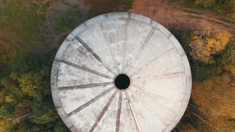 Large white sphere with hole on top located in dense forest Stock Footage 152586105