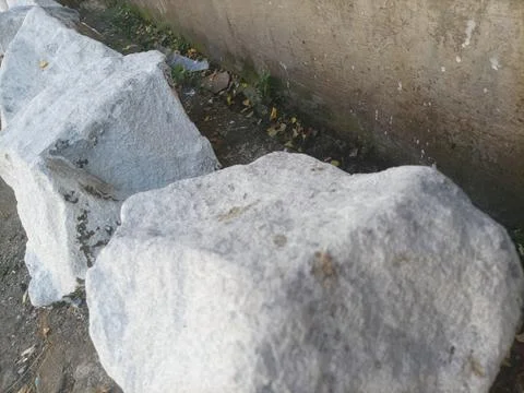 Large white stone on the roadside Stock Photos