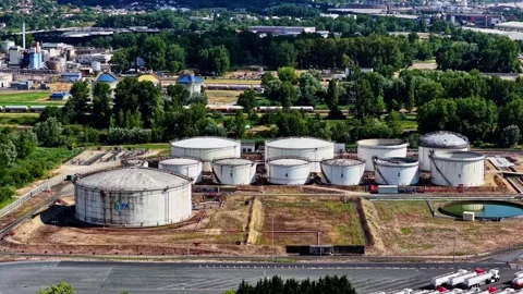 Large white tanks storing crude oil and fuel at a petrochemical refinery plant Stock Footage 341536900