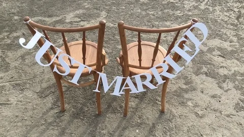 Large white text 'JUST MARRIED' wedding sign set hang on chair Video stock 84042661