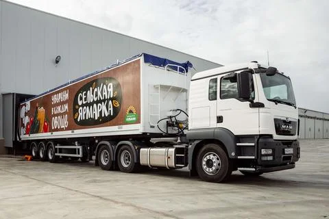 A large white truck pulls out of the hangar. wagon trailer. Stock Photos