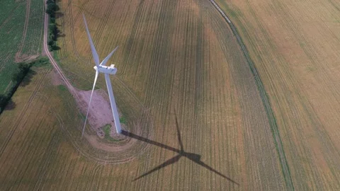 Large White Wind Turbine Rotating in a Golden Field During a Bright Sunny Video stock 341838179
