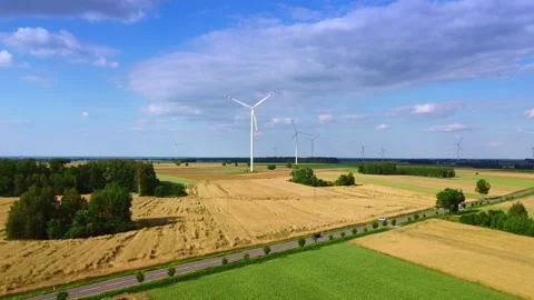 Large white wind turbines spinning over rural farmland landscape Stock-Footage 342591986