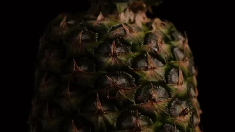 Large whole pineapple on a black background close-up Stock Footage 154631570