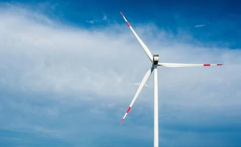 Large wind generator close-up against the sky and clouds Stock Photos