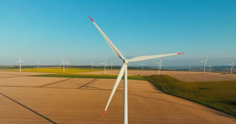 Large wind turbine rotating blades on blue sky aerial view background golden Stock Footage 301876458
