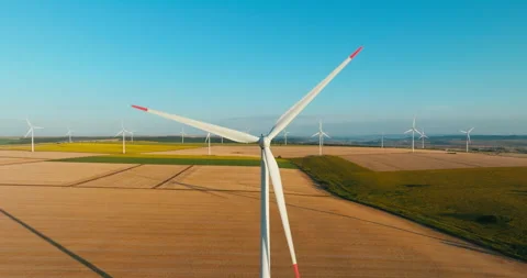 Large wind turbine rotating blades on blue sky aerial view background golden Stock Footage 301877073