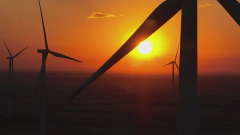 Large wind turbines and orange sun Video stock 210768078
