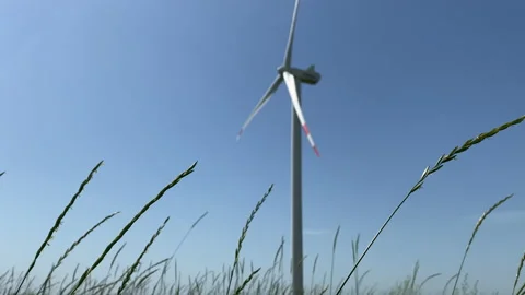 Large wind turbines with blades in field blue sky wind park. Cinematic shoot Stock Footage 159544919