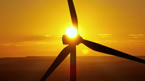 Large wind turbines with blades in field aerial view bright orange sunset Stock Footage 232368720