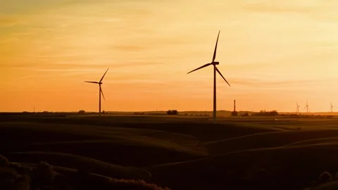 Large wind turbines generating renewable electricity at sunset. Giant wind Stock Footage 313683963