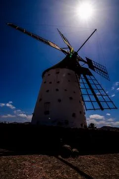 A large windmill is standing in the middle of a field Stock Photos