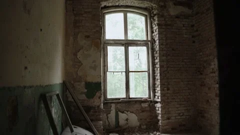 Large window with broken sill in empty ruined room, stabilized camera backwards. Stock Footage 223361926
