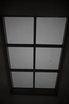 Large window in the ceiling. Faint light through glass. Grey day outside th.. Stock Photos
