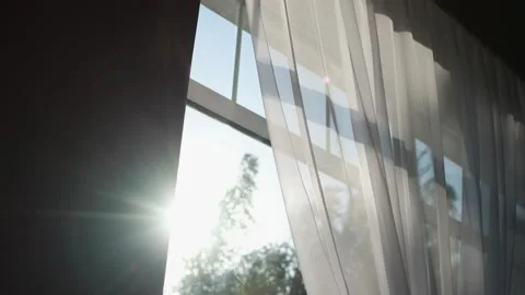 A large window with a curtain, outside the window the spring wind is blowing and Stock Footage 141637213